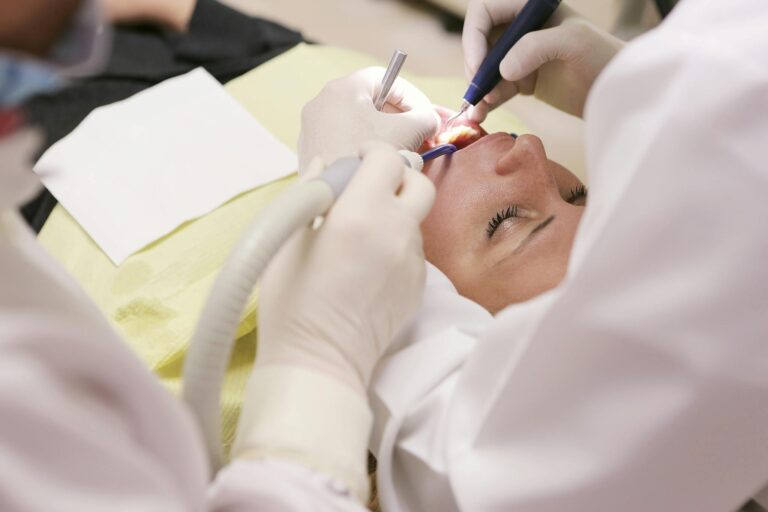 People Wearing White Shirt Working on Woman"s Teeth